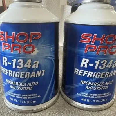 Sale Photo Thumbnail #59: Two 12 oz cans of Shop Pro R-134a automotive A/C refrigerant.