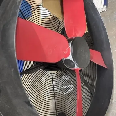 Sale Photo Thumbnail #105: Large industrial drum fan featuring bright red fan blades and a black wire protective guard housing.
