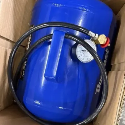Sale Photo Thumbnail #119: Duralast 7-gallon portable air tank in blue, featuring attached hose and pressure gauge, stored inside a cardboard box.