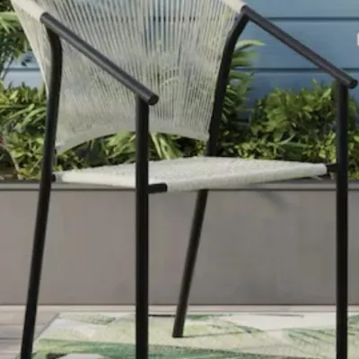 Sale Photo Thumbnail #161: Modern outdoor armchair featuring a black metal frame and woven white rope seat and backrest.