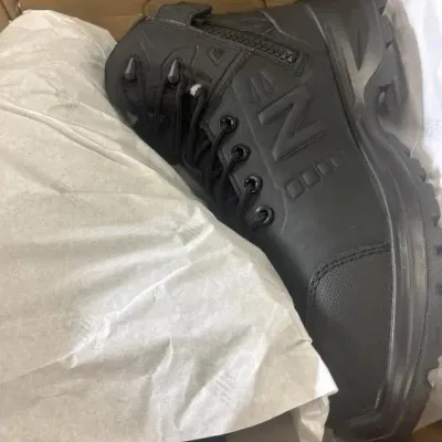 Sale Photo Thumbnail #32: Black New Balance tactical-style boot with side zipper, shown inside its original packaging.