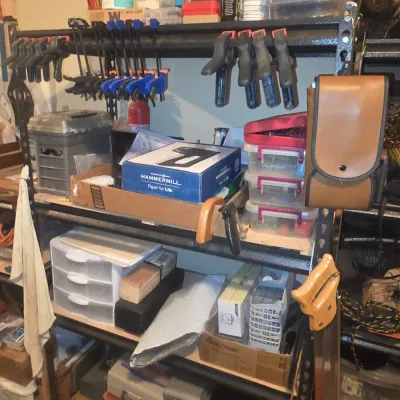 Sale Photo Thumbnail #72: Metal garage shelving unit stocked with various hand tools, clamps, storage drawers, and workshop supplies.
