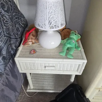 Sale Photo Thumbnail #16: White painted faux bamboo and wicker nightstand topped with a modern white cutout table lamp and Ty Beanie Babies.