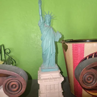 Sale Photo Thumbnail #93: Vintage resin Statue of Liberty replica figurine mounted on a tiered pedestal base.