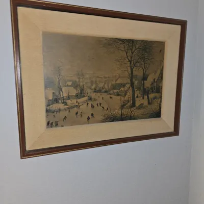 Sale Photo Thumbnail #24: Framed reproduction print of a classic Dutch winter landscape scene with ice skaters, set in a wide linen mat and dark wooden frame.