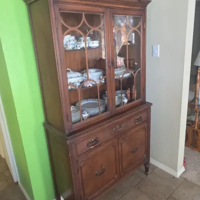 Sale Photo Thumbnail #94: Vintage Chippendale-style wood hutch cabinet with glass display doors, carved pediment crest, and bottom storage drawers.
