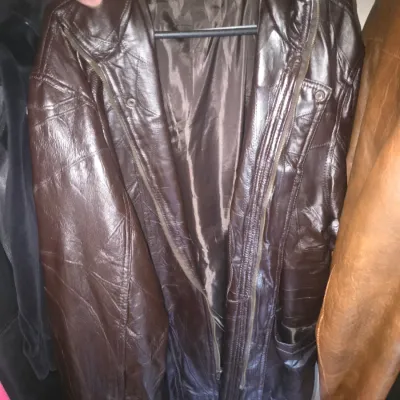 Sale Photo Thumbnail #64: Vintage dark brown patchworked leather jacket with zip closure and fabric lining.