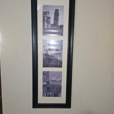 Sale Photo Thumbnail #53: Framed wall art featuring three black and white photo prints of Italian landmarks, including the Leaning Tower of Pisa, presented in a black wooden frame with a white mat.