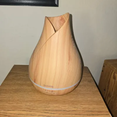 Sale Photo Thumbnail #55: VicTsing light wood grain finish essential oil diffuser with tulip-inspired shape.