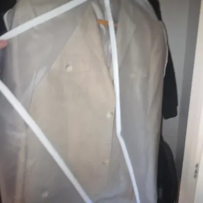 Sale Photo Thumbnail #67: Men's tan suede jacket inside a protective zippered garment bag.