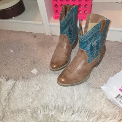 Sale Photo Thumbnail #11: Pair of women's short Western cowboy boots featuring light brown faux-leather feet and teal embroidered shafts.