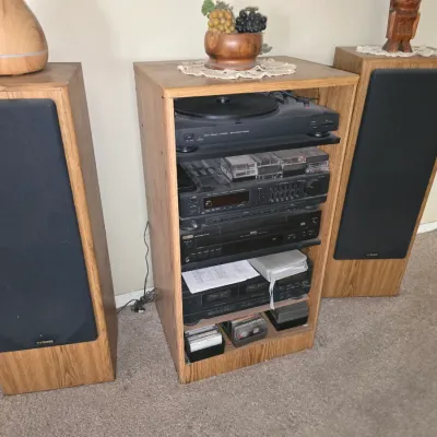 Sale Photo Thumbnail #56: Vintage Fisher stereo component system housed in a light oak cabinet with two matching tall floor speakers, including a turntable, receiver, tape deck, and CD player.