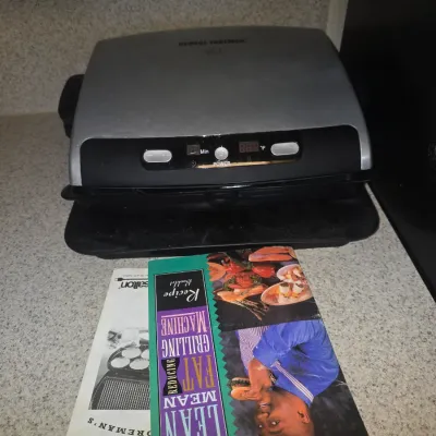 Sale Photo Thumbnail #121: George Foreman Lean Mean Fat Reducing Grilling Machine, model GR30, with original owner's manual and recipe booklet.
