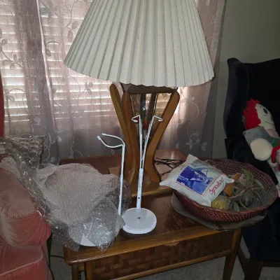 Sale Photo Thumbnail #38: Vintage table lamp with a wooden base and pleated fabric shade, set on a mid-century modern wooden end table.