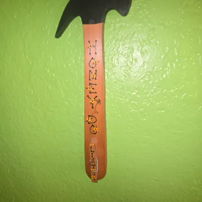 Sale Photo Thumbnail #108: Hand-painted wooden hammer wall hanging reading 'Honey Do List' with an attached clothespin clip.