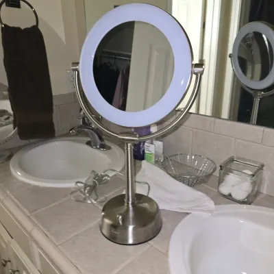 Sale Photo Thumbnail #12: Zadro lighted dual-sided vanity makeup mirror with a brushed nickel finish, sitting on a bathroom counter.