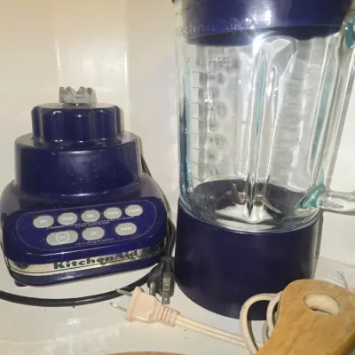 Sale Photo Thumbnail #120: Vintage KitchenAid 5-speed blender in cobalt blue featuring a heavy glass pitcher and push-button controls.