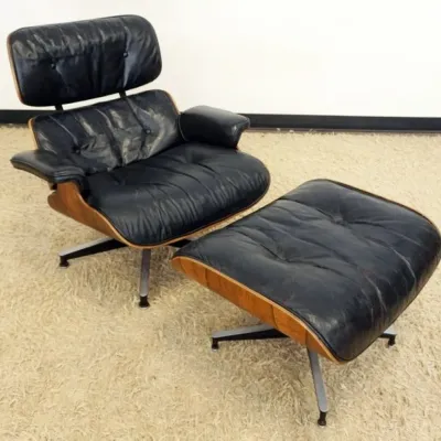 Sale Photo Thumbnail #219: 1218	HERMAN MILLER EAMES LOUNGE CHIAR AND OTTOMAN, SOME WEAR TO LEATHER, CHAIR APPROXIMATELY 34 IN X 35 IN 32 IN H, OTTOMAN APPROXIMATELY 26 IN X 22 IN X 17 IN H																																																																																														