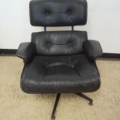 Sale Photo Thumbnail #217: 1216	VINTAGE EAMES STYLE ARMCHAIR, WEAR TO VINYL, APPROXIMATELY 33 IN X 30 IN X 36 IN HIGH																																																																																																																																																																					