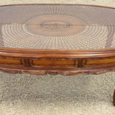 Sale Photo Thumbnail #192: 1191	OVAL FRUITWOOD GLASS TOP COFFEE TABLE W/WOVEN CANE UNDER GLASS, APPROXIMATELY 45 IN X 22 IN X 19 IN																																																																																																																																																							