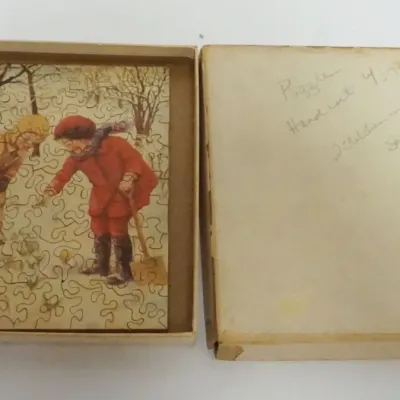 Sale Photo Thumbnail #126: 1126	ANTIQUE WOOD JIG SAW PUZZLE OF 2 CHILDREN PLAYING IN SNOW, APPROXIMATELY 5 IN  X 7 IN																																																																																																																																																																					