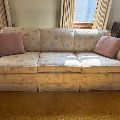Sale Photo Thumbnail #62: Vintage three-cushion floral sofa with pleated skirt and two matching dusty rose accent pillows.