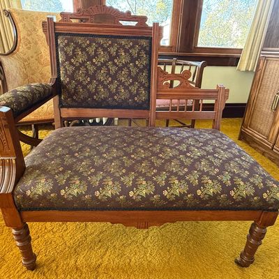 Sale Photo Thumbnail #46: Antique carved wooden gossip bench featuring dark floral tapestry upholstery and turned legs.