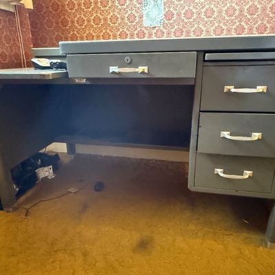 Sale Photo Thumbnail #8: Mid-century industrial gray metal office desk featuring silver-tone handles, a center drawer with keyhole, and a side return extension.