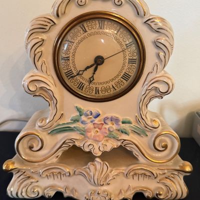 Sale Photo Thumbnail #27: Vintage Telechron porcelain mantel clock featuring rococo-style scrollwork, pastel floral accents, and gold trim.