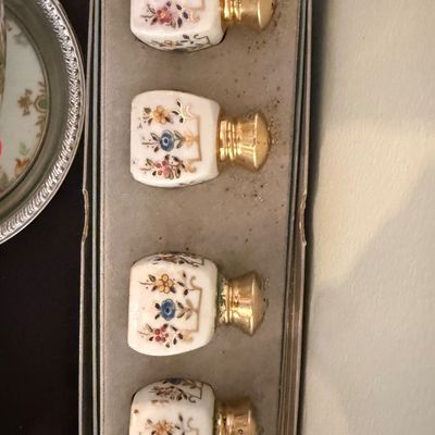 Sale Photo Thumbnail #29: Set of four vintage hand-painted porcelain salt and pepper shakers with gold-tone caps, presented in their original box.