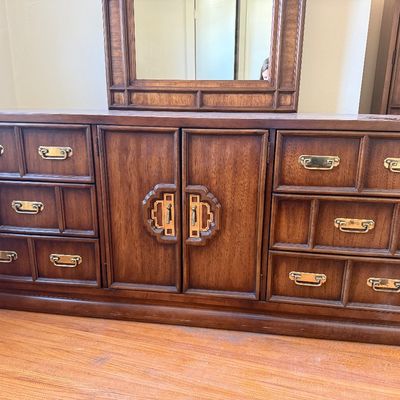 Sale Photo Thumbnail #2: Vintage Asian modern low dresser with matching framed mirror, featuring decorative campaign-style brass hardware and central cabinet doors.