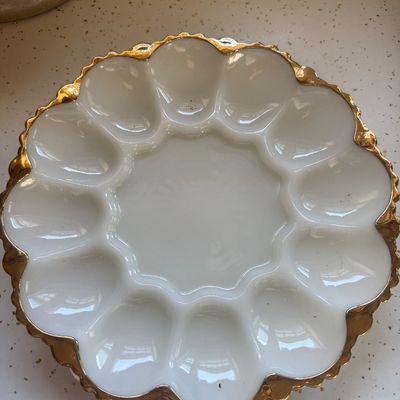 Sale Photo Thumbnail #17: Vintage white milk glass deviled egg platter featuring a scalloped gold-gilt rim and twelve egg wells.