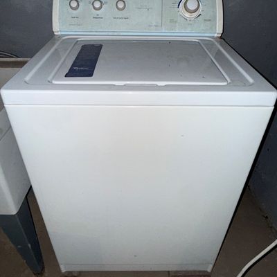 Sale Photo Thumbnail #13: Vintage white Whirlpool top-load washing machine featuring a teal-tinted control panel with multiple dial settings.