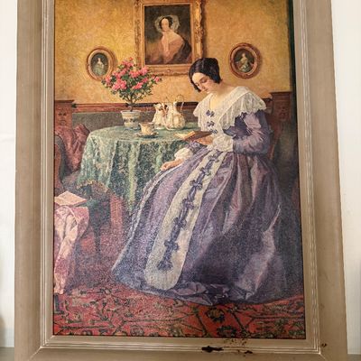 Sale Photo Thumbnail #39: Framed vintage art print depicting a Victorian-style interior scene of a woman in a purple dress reading, housed in a simple wooden frame.