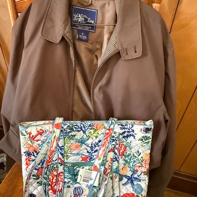 Sale Photo Thumbnail #64: Men's brown Keeker Bay jacket hanging on a chair, paired with a colorful ocean-themed quilted tote bag in the foreground.