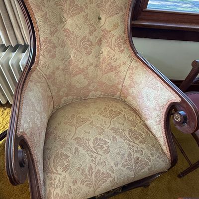 Sale Photo Thumbnail #49: Vintage high-back armless swivel rocker upholstered in a pink and cream floral damask pattern with dark wood accents.