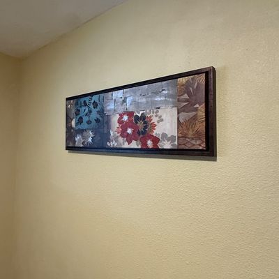 Panoramic framed contemporary canvas print featuring a patchwork motif of floral and botanical designs.