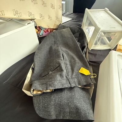 Men's vintage charcoal gray wool suit trousers, displayed inside a original branded clothing box.