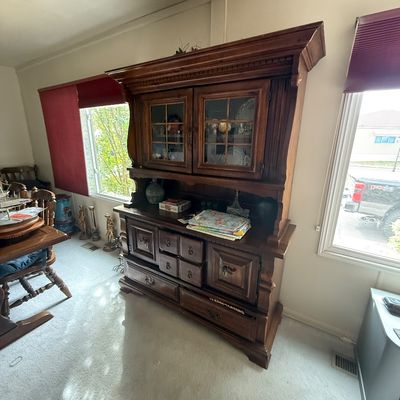 Traditional dark stain wood hutch featuring upper glass-front cabinet doors, multiple drawers, and lower panel doors.