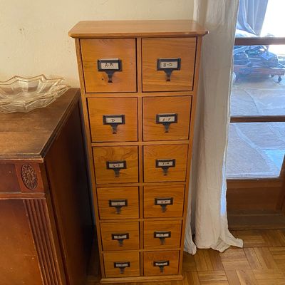 Sale Photo Thumbnail #20: Tall vintage light oak card catalog cabinet featuring twelve drawers with metal label holder pulls.