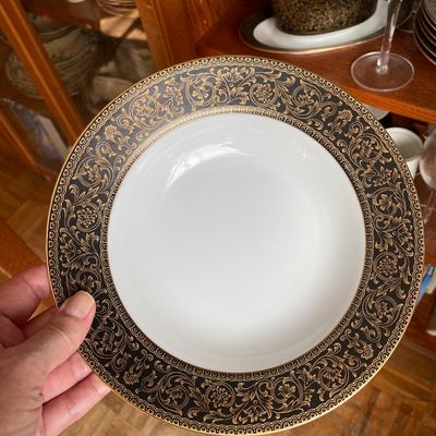 Sale Photo Thumbnail #188: Fine China by Sango featuring a wide black rim embellished with intricate gold filigree scrolling.