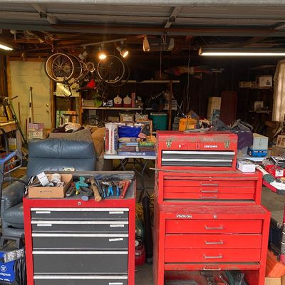 Sale Photo Thumbnail #9: Red metal rolling tool chests including Craftsman and Stack-On brands, filled with various hand tools in a garage setting.