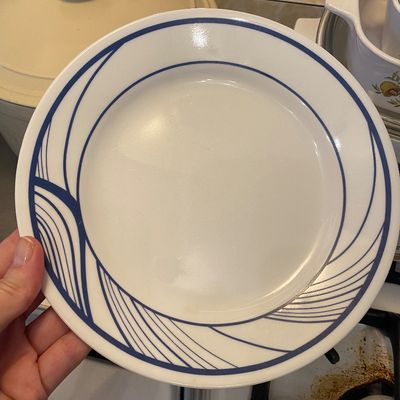 Sale Photo Thumbnail #14: Vintage Corelle white dinner plate featuring a blue abstract line wave pattern along the rim.