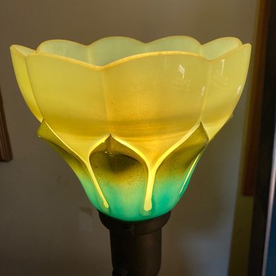 Sale Photo Thumbnail #69: Vintage Art Nouveau style table lamp featuring a frosted yellow-to-teal tulip-shaped glass shade and an ornate metal base.