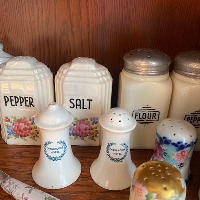 Sale Photo Thumbnail #100: Collection of vintage ceramic and glass shakers, including Art Deco salt and pepper shakers, Cranbrooke Hotel sets, and milk glass range shakers.