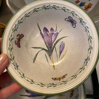 Sale Photo Thumbnail #16: Portmeirion Botanic Garden crocus pattern bowl featuring a green trim rim and butterfly details. Showing heavy crazing throughout the interior glaze.