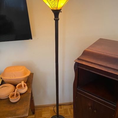 Sale Photo Thumbnail #37: Mission-style stained glass torchiere floor lamp with amber panels and dark metal base.