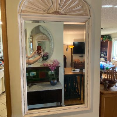 Sale Photo Thumbnail #39: French Country style whitewashed wall mirror featuring a painted fan and scroll pediment frame.