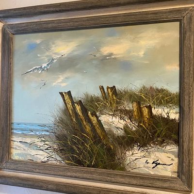 Sale Photo Thumbnail #89: Framed vintage oil painting depicting a coastal dune scene with seagulls, set in a weathered grey wooden frame.
