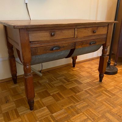 Sale Photo Thumbnail #24: Antique rustic wooden baker's cabinet featuring upper drawers, turned legs, and two lower galvanized metal flour bins with pull handles.